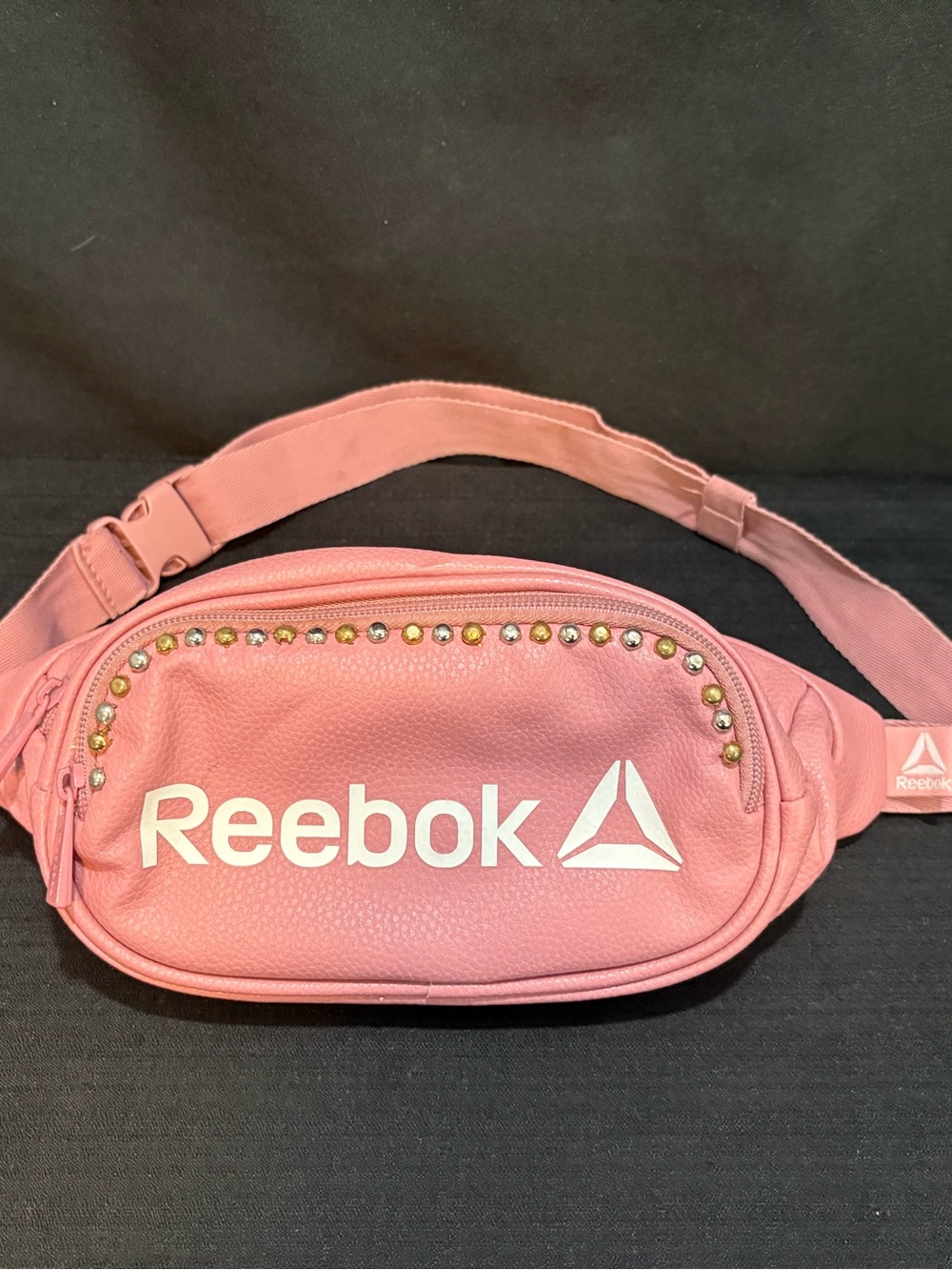 pink faux-leather Reebok fanny pack customized w/ a row of metallic studs